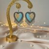 Heart-shaped oxidised jhumka with blue tones and golden flakes Heart-shaped oxidised jhumka with blue tones and golden flakes